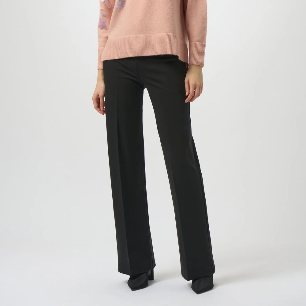 Woman wearing a pink sweater and the black Heavy Knit Wide Leg Pull On Pants from Joseph Ribkoff
