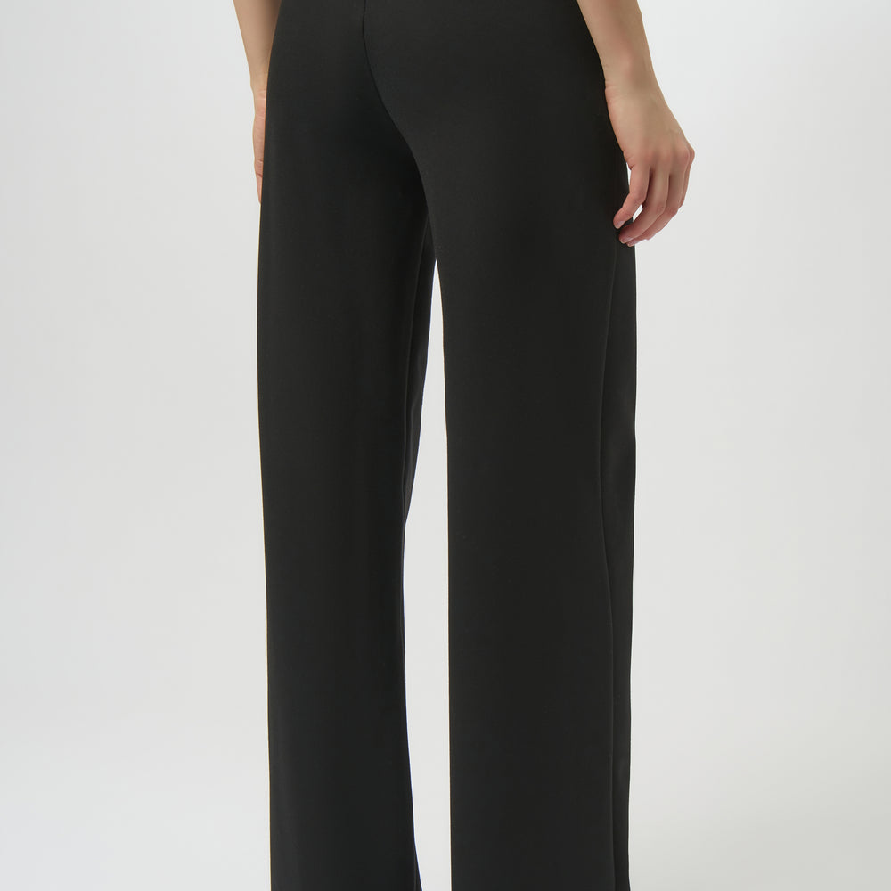 
                      
                        Black wide-leg pant paired with a white top and heeled shoes
                      
                    