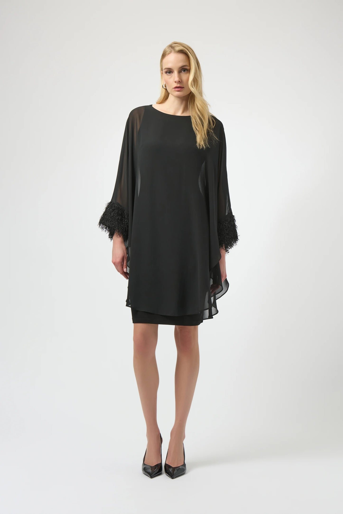 A woman wearing the Joseph Ribkoff Silky Knit & Chiffon Layered Dress with Fringe Detail