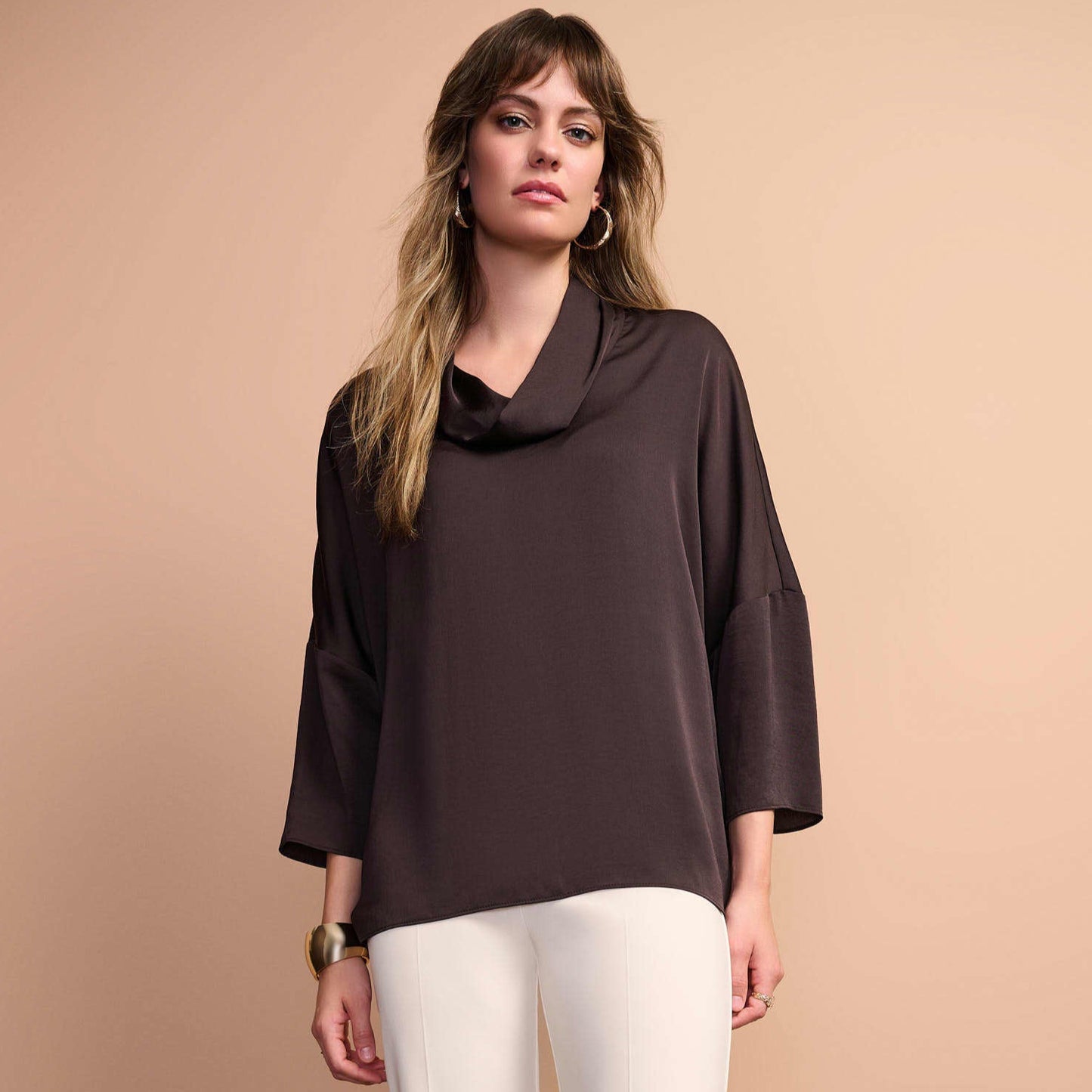 Woman wearing a dark brown satin cowl neck blouse from Joseph Ribkoff. 