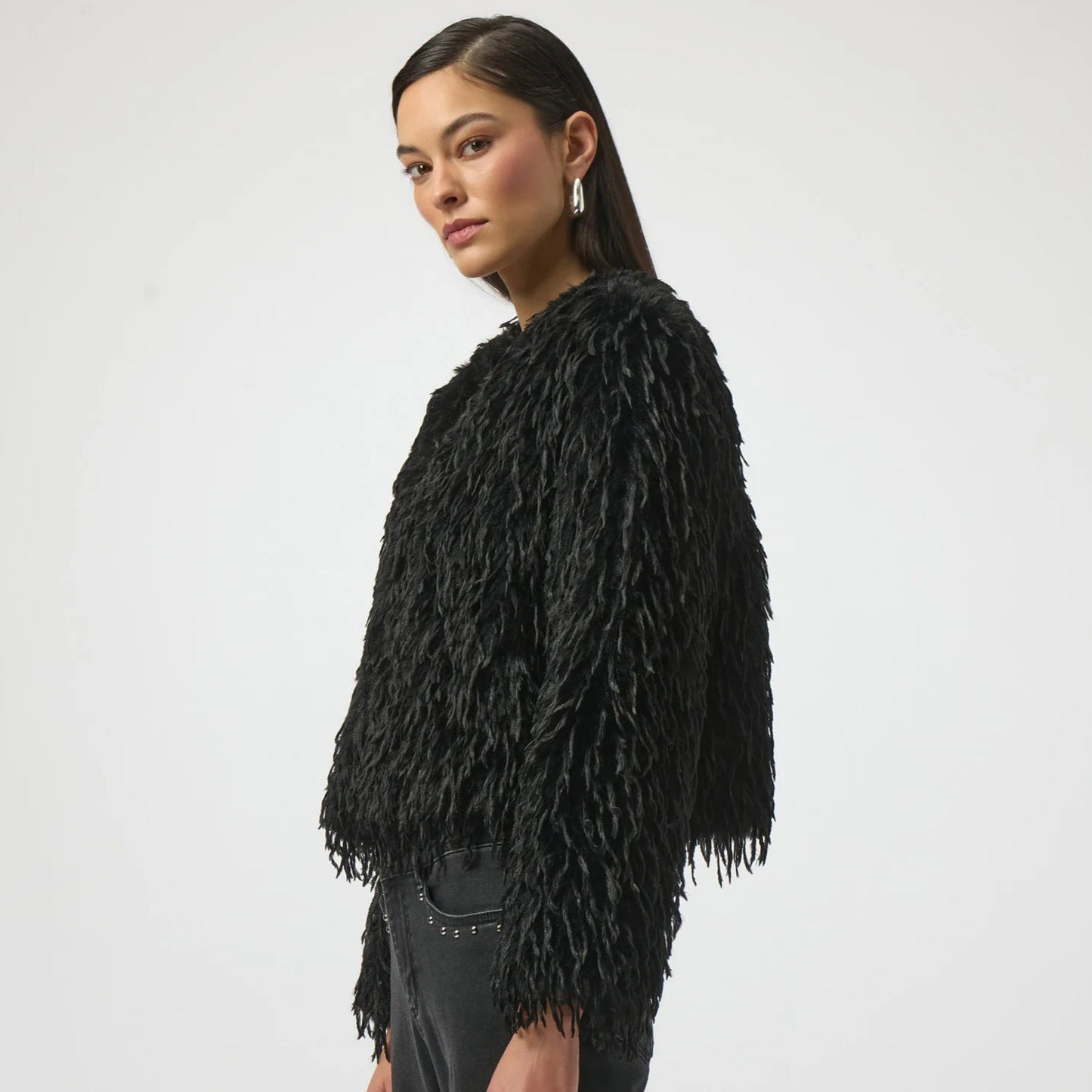 A woman wearing the black Faux Fur Collarless Boxy Jacket by Joseph Ribkoff