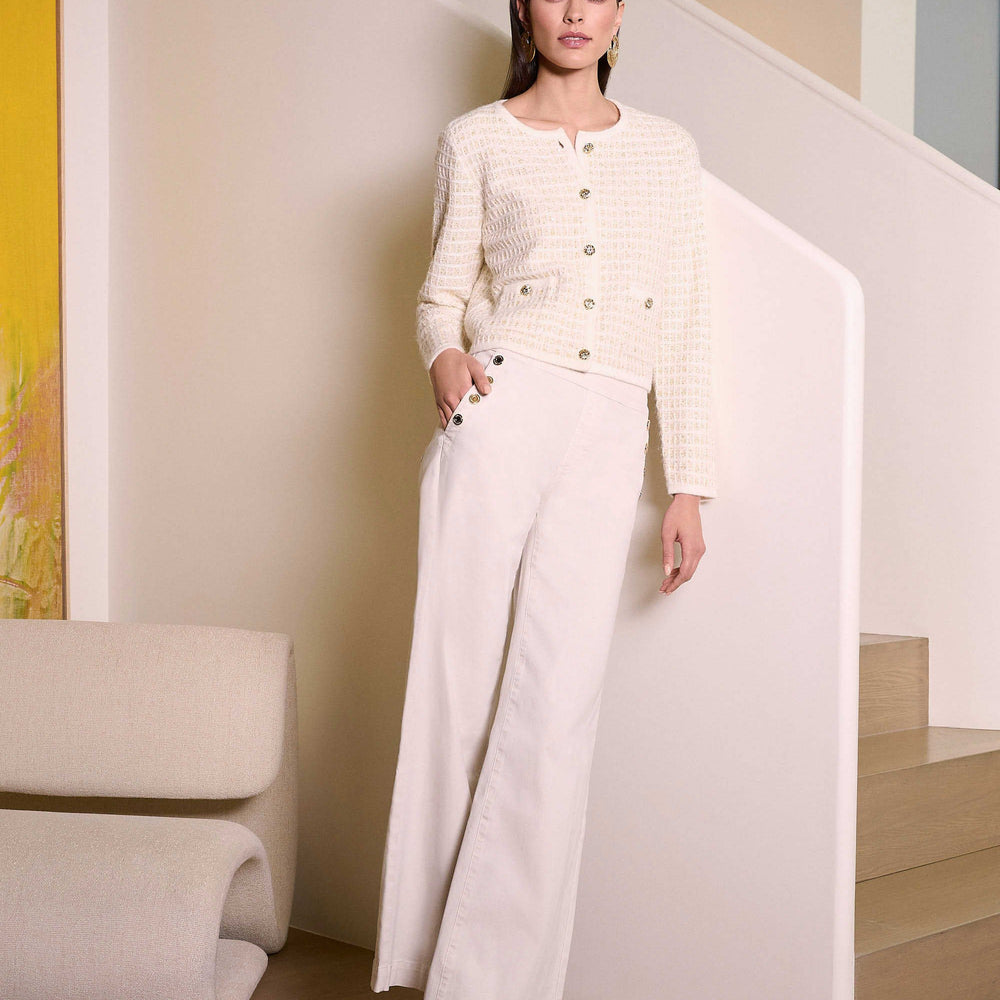 
                      
                        A woman wearing the Joseph Ribkoff Classic Wide Leg Pull-On Jeans with a matching sweater in a modern home
                      
                    