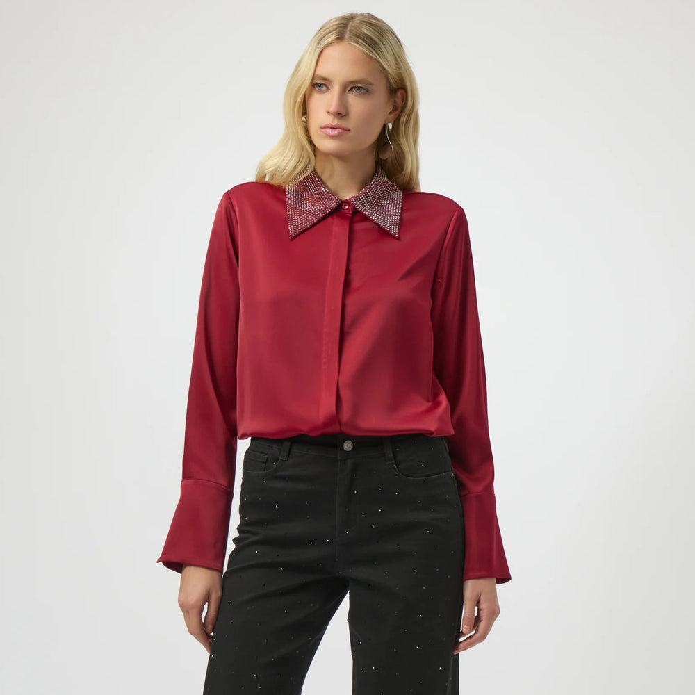 A woman wearing the red Satin Button-Front Blouse with Embellished Collar from Joseph Ribkoff