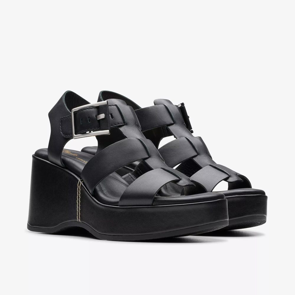 
                      
                        The black leather Manon Cove Wedge Sandals by Clarks
                      
                    