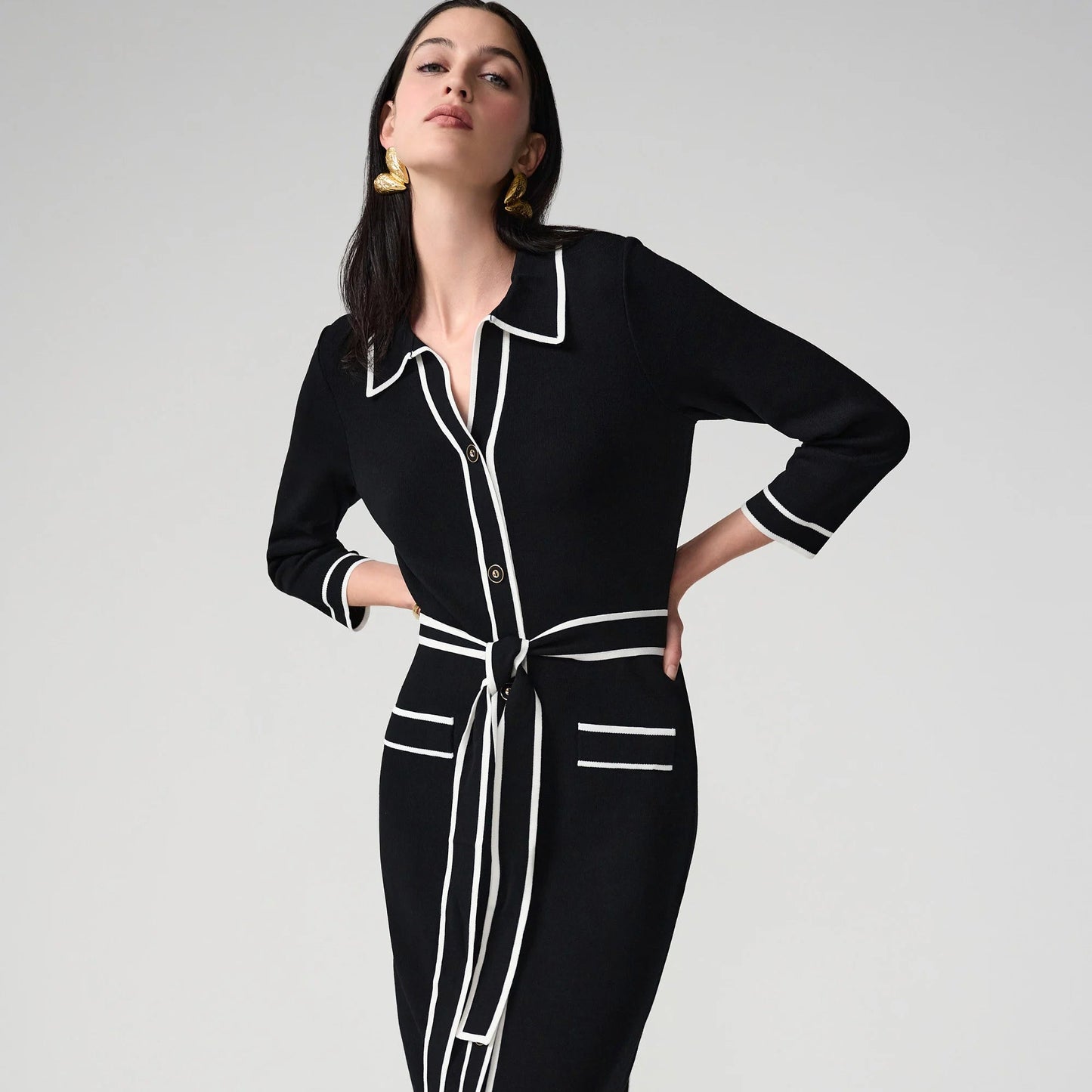 A woman wearing a black and white shirt dress from Joseph Ribkoff