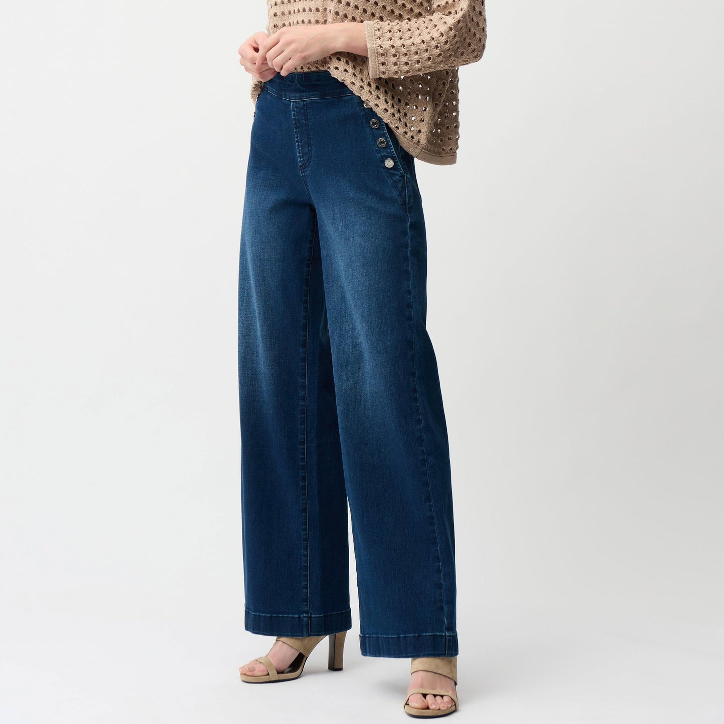 Woman wearing a beige knitted sweater and blue wide leg pull-on jeans from Joseph Ribkoff