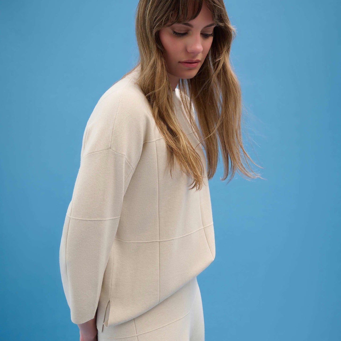 A woman wearing the Brushed Viscose Straight Sweater with Mock Neck from Joseph Ribkoff