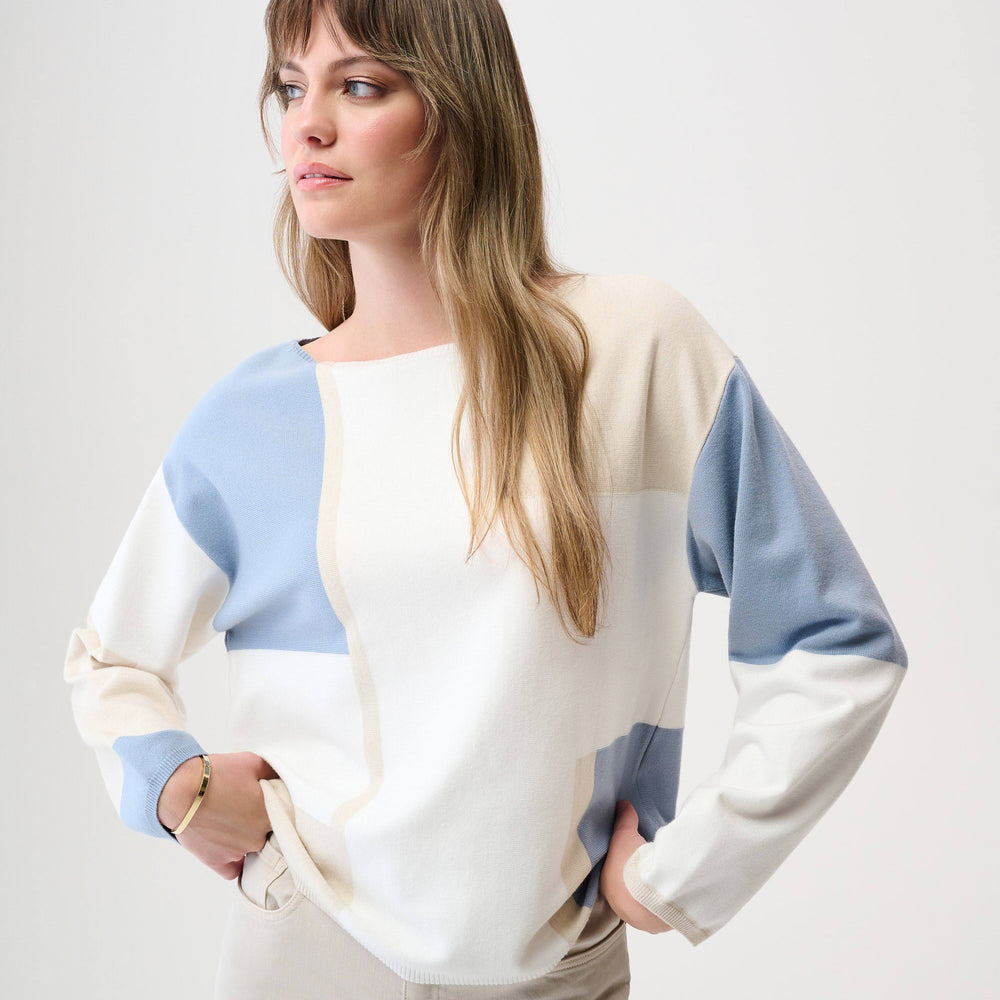 A woman wearing a color block pullover sweater from Joseph Ribkoff