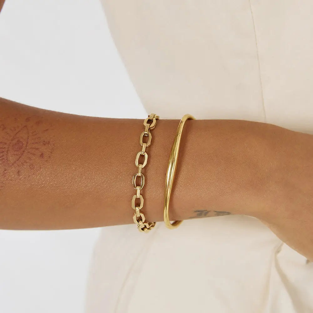 
                      
                        The Teddy Gold Bracelet by Arms of Eve styled with another bracelet
                      
                    