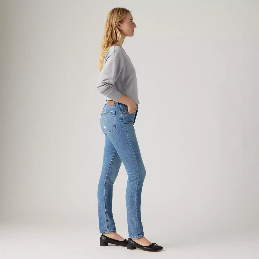 
                      
                        Side view of a woman wearing the 501 Skinny Jean in the medium wash Historically Blue by Levi's
                      
                    