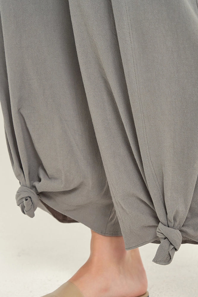 close up view of woman wearing grey knotted hem pants