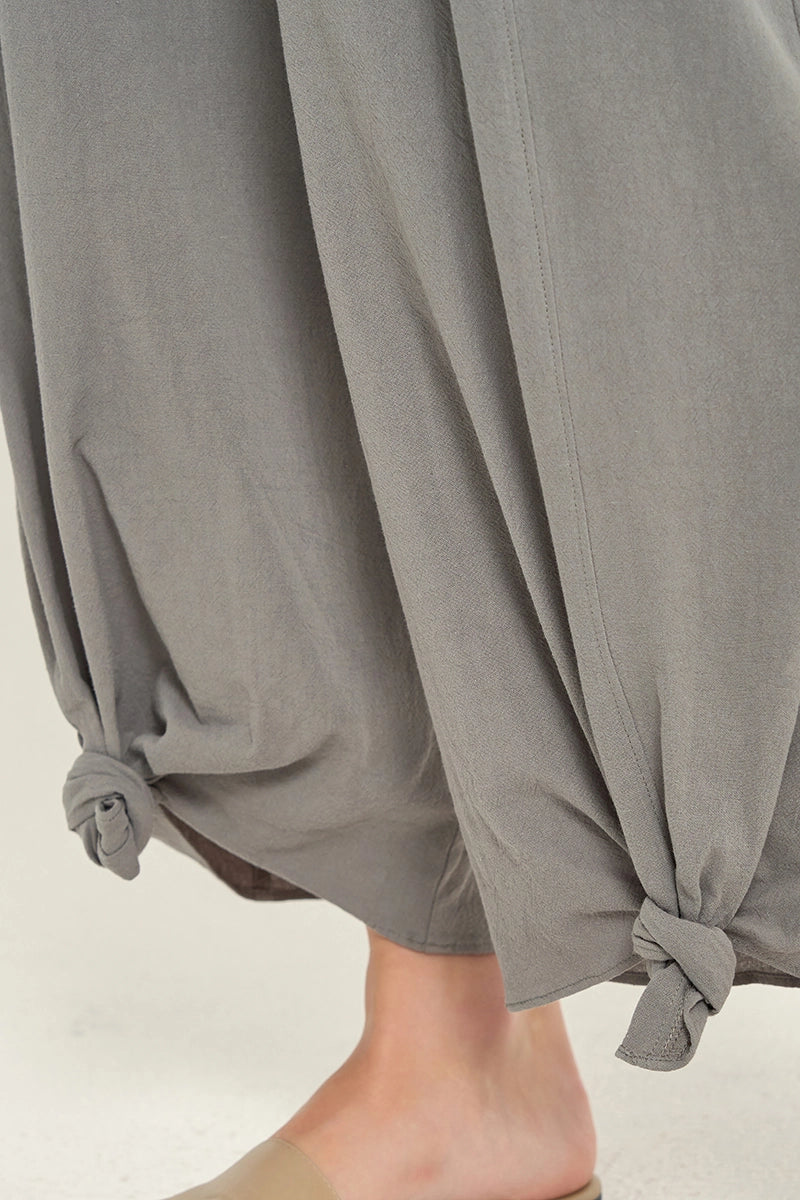 close up view of woman wearing grey knotted hem pants