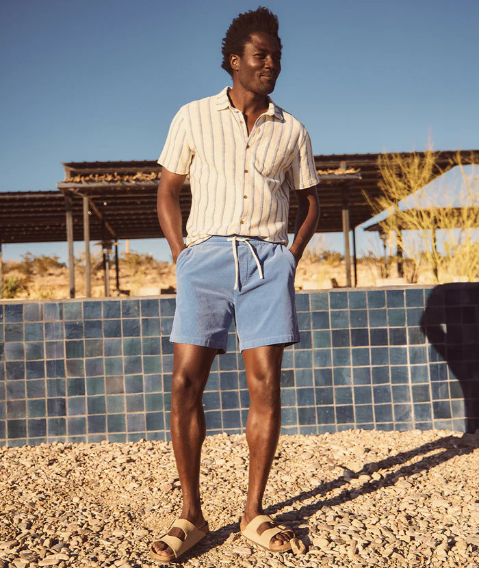 A man outside wearing Marine Layer's 6" Saturday Cord Short in the color Marina