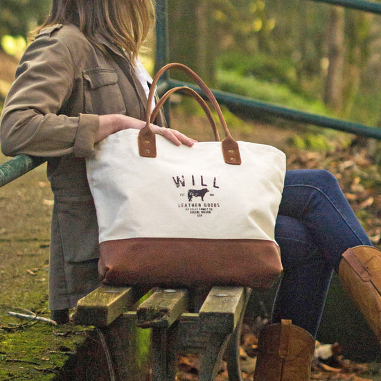 woman sitting next to the Will Leather Goods Utility Tote in Natural