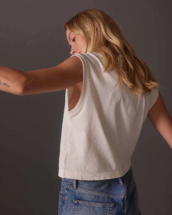 back Front view of model wearing a relaxed fit off white color muscle tee