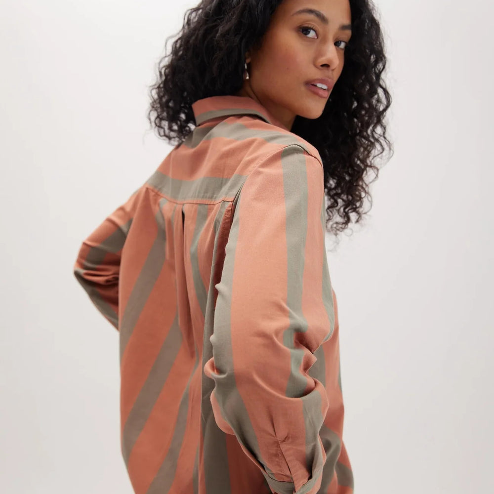 Back view of a woman wearing the Venice Button Up Shirt by Richer Poorer in the color Russet Sage Stripe