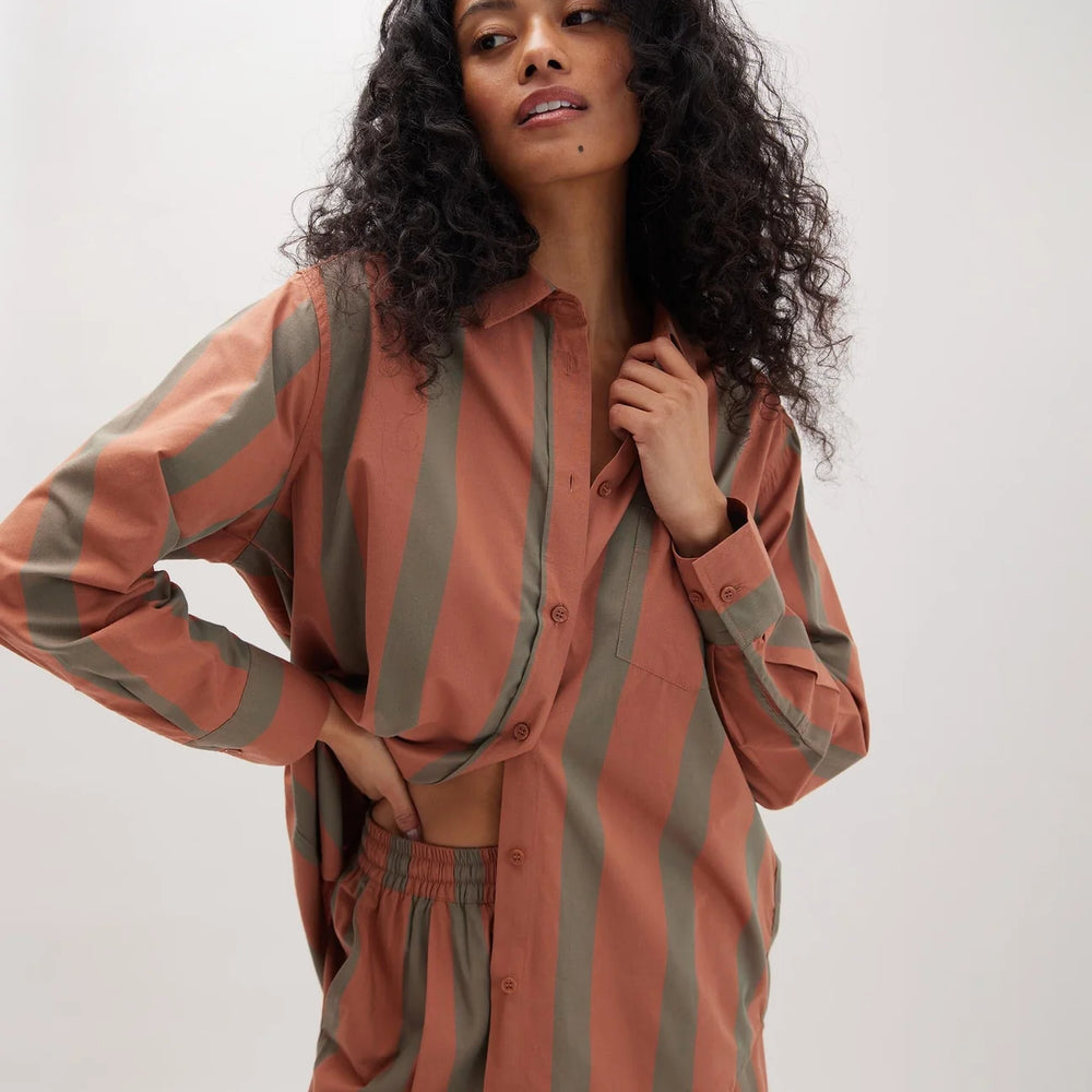 A woman wearing the Venice Button Up Shirt by Richer Poorer in the color Russet Sage Stripe