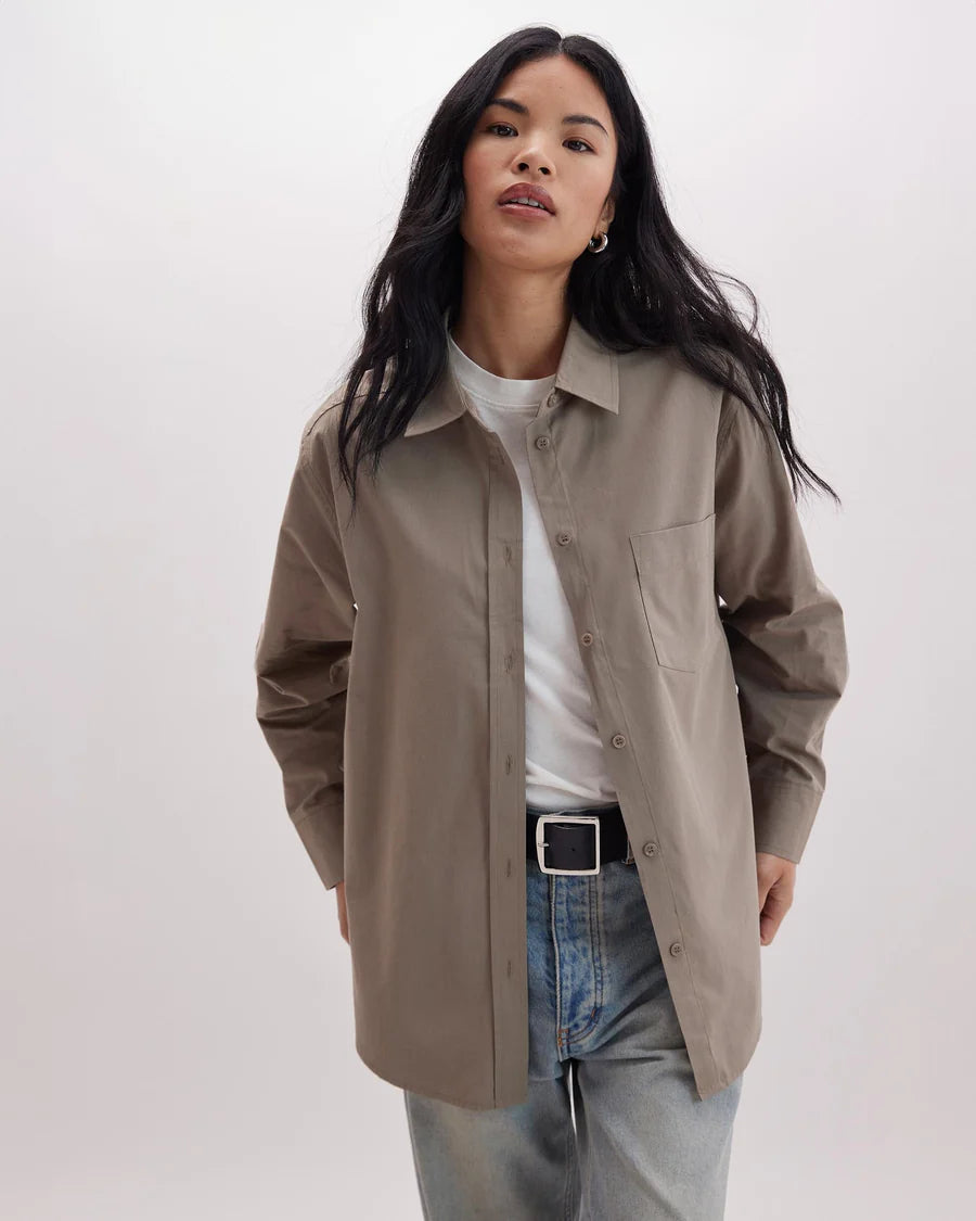 A woman wearing the Venice Button Up Shirt by Richer Poorer in the color Warm Grey