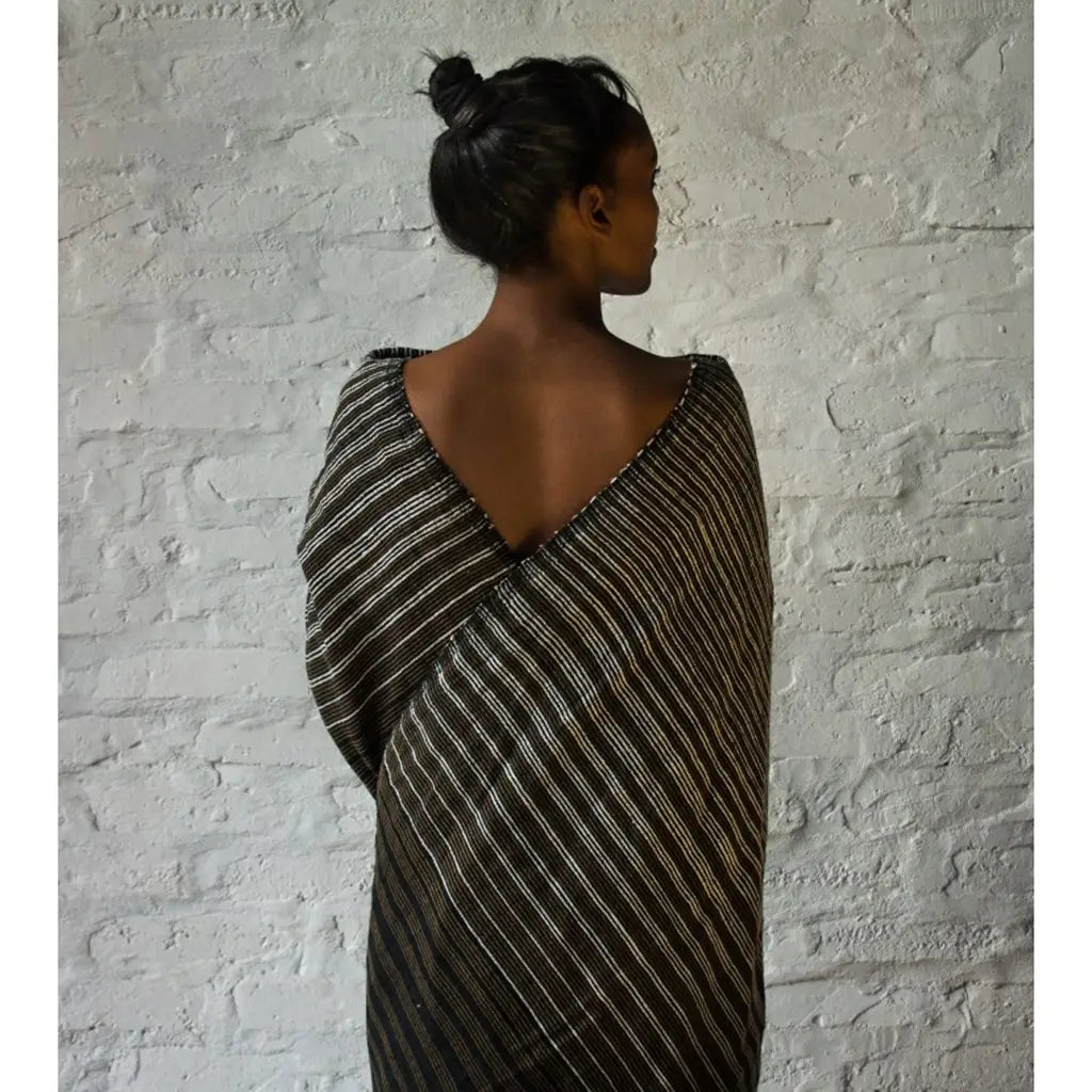 Woman wrapped in the Zebra Ethiopia Handloom Wrap Scarf by Slate + Salt