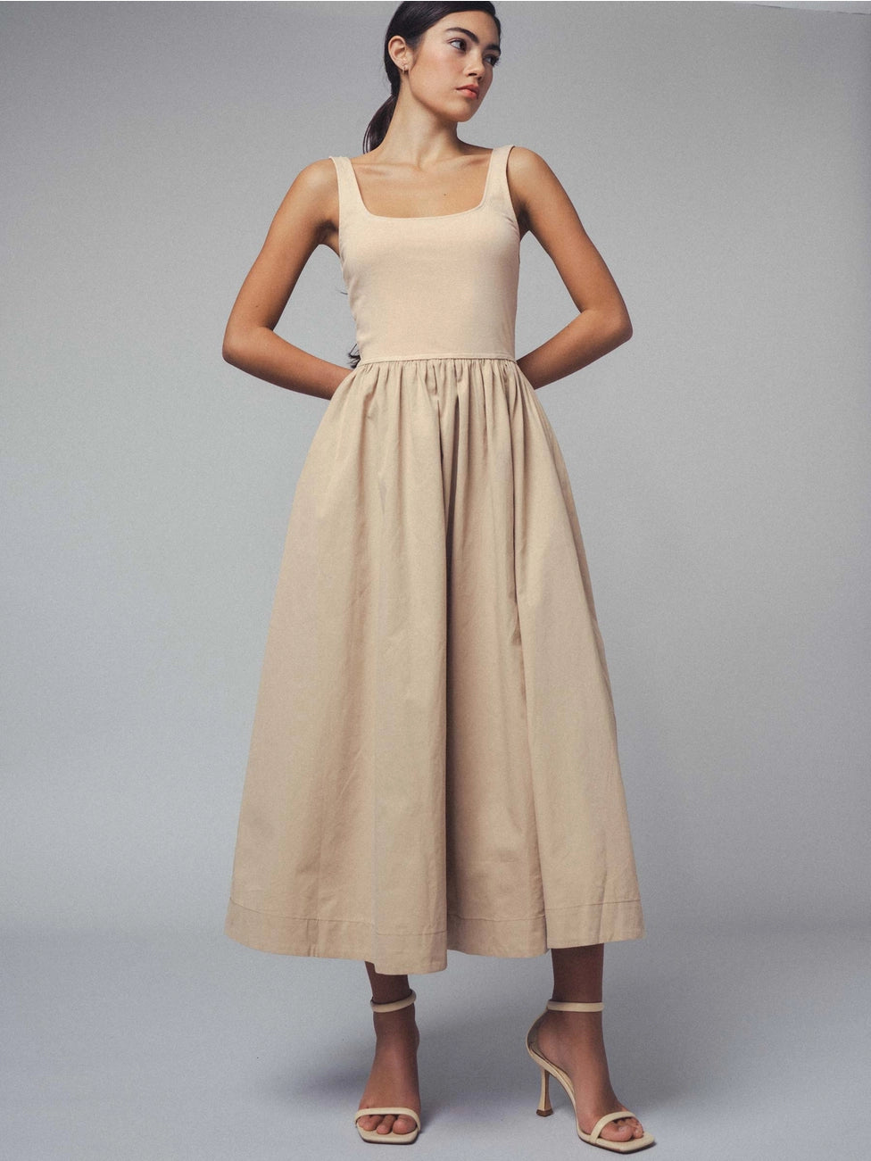 Perfect for everyday wear, this cotton midi dress available at Harbour Thread offers endless ways to style with a fitted bodice and gathered waist. 
