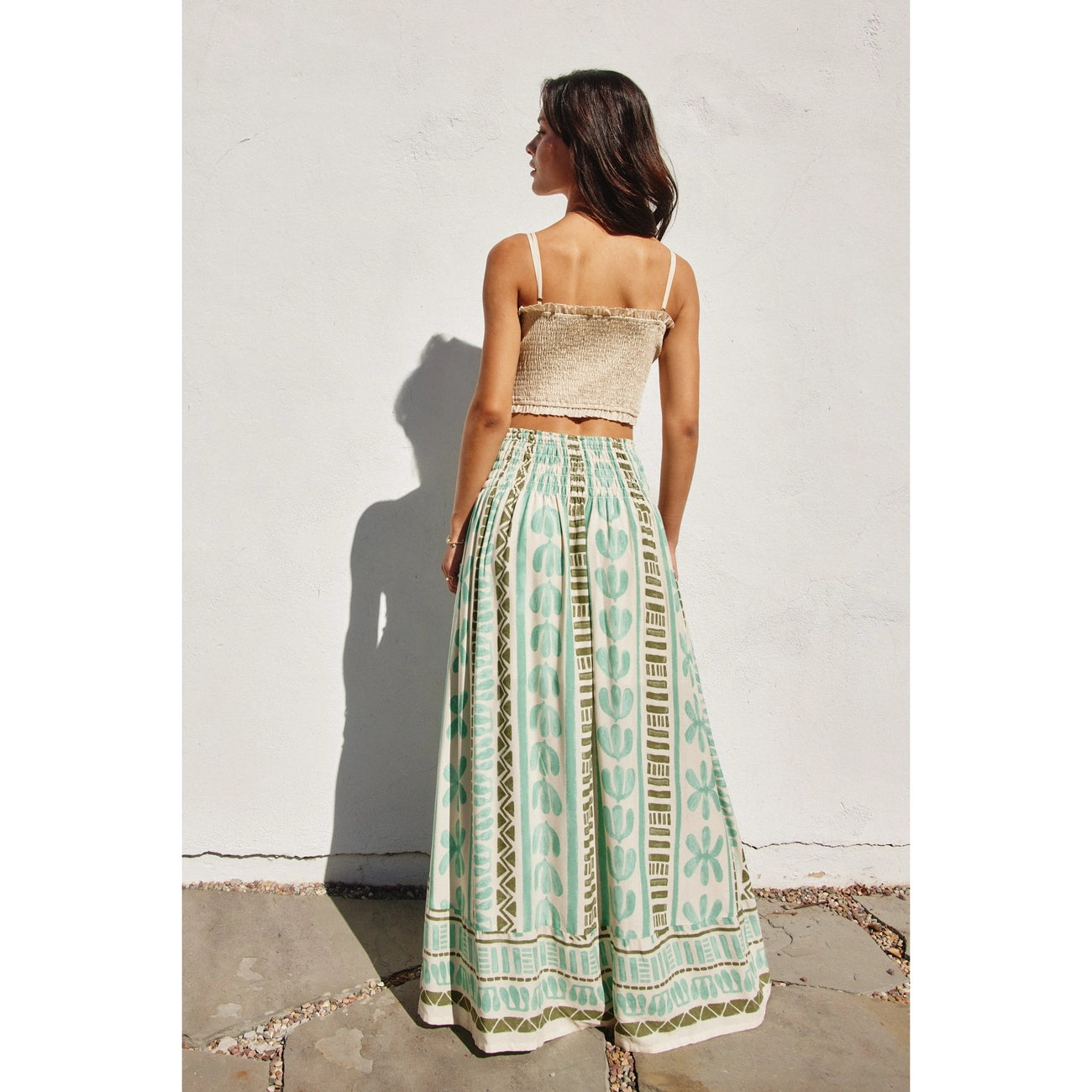 This resort-ready maxi skirt at Harbour Thread offers a fitted smocked waist that flares into a flowing silhouette