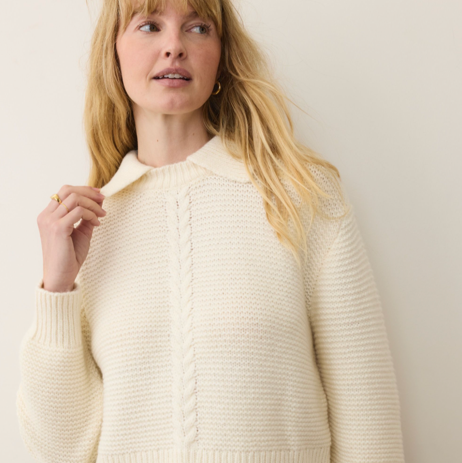 Woman wearing a cream-colored sweater from Marine Layer