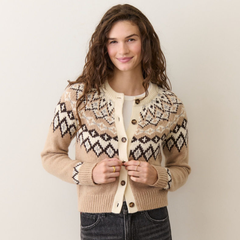 A woman wearing a neutral fair isle cardigan from Marine Layer