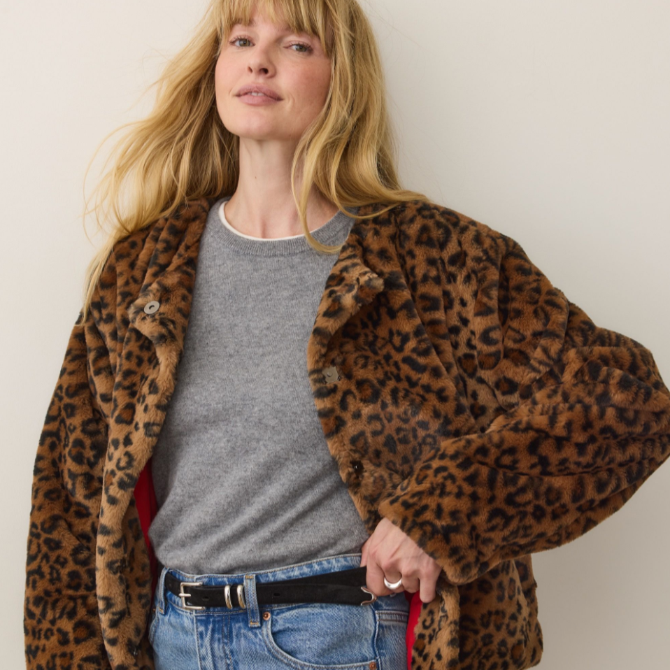 A woman wearing the Tessa Leopard Jacket from Marine Layer over a grey t-shirt