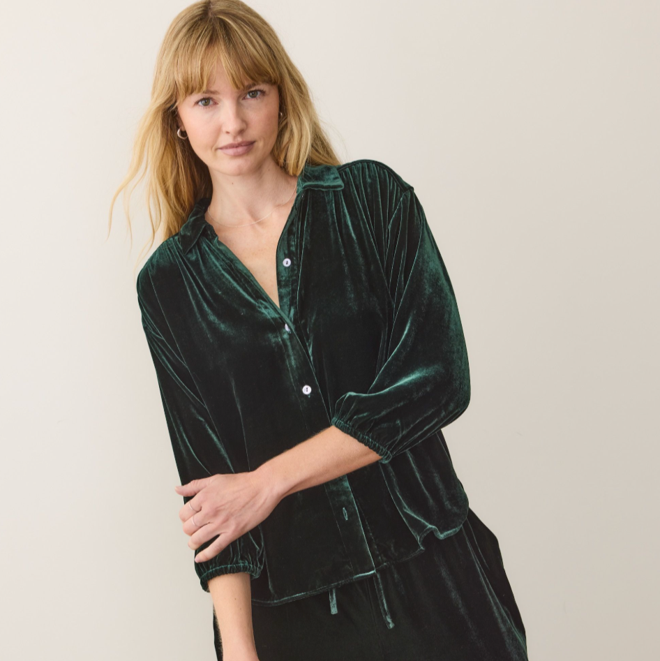 Woman wearing a dark green velvet shirt Marine Layer