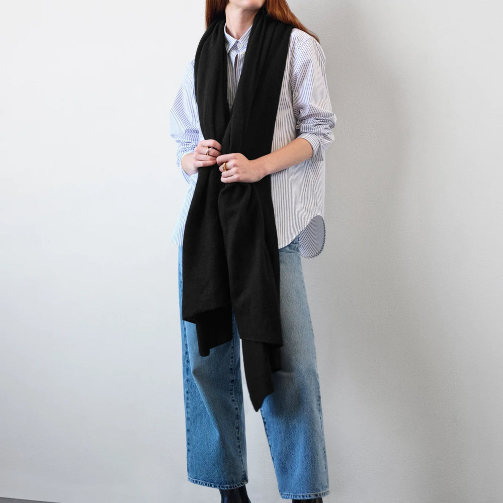 Woman wearing the Black Cashmere Travel Wrap by White + Warren