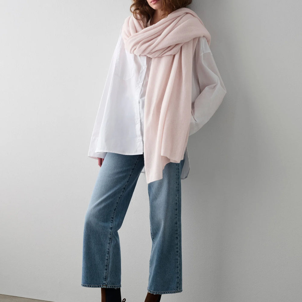 Woman with the Pink Sand Cashmere Travel Wrap by White + Warren wrapped around her 