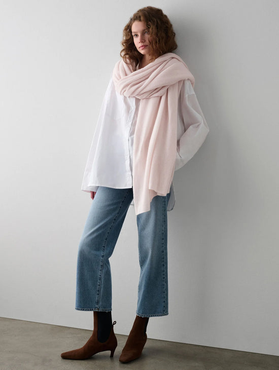 Woman with the Pink Sand Cashmere Travel Wrap by White + Warren wrapped around her 
