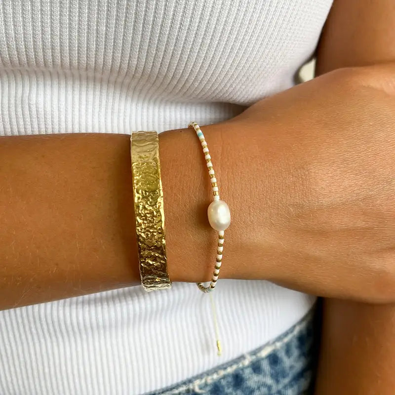 
                      
                        person wearing the White and Blue Turquoise Charlotte Bracelet by Arms of Eve.
                      
                    