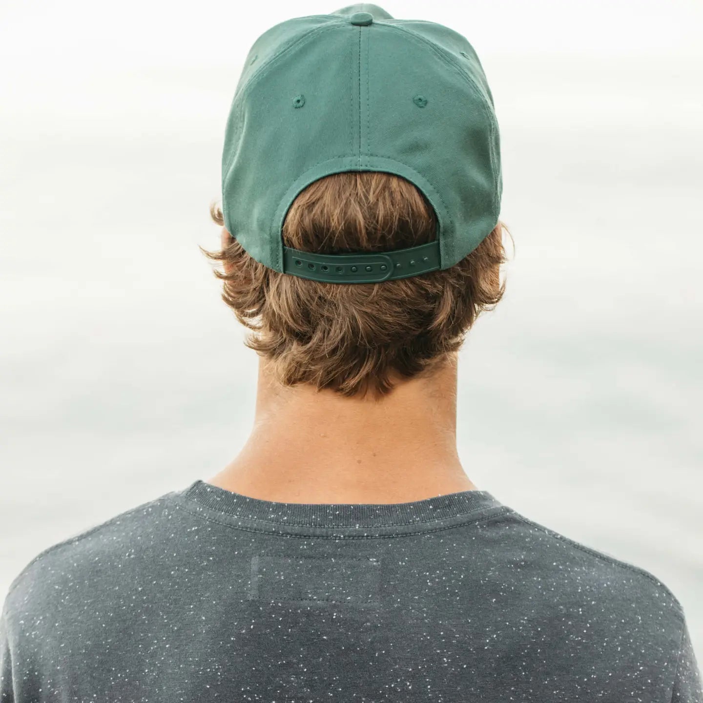 Person wearing a green cap from Mollusk
