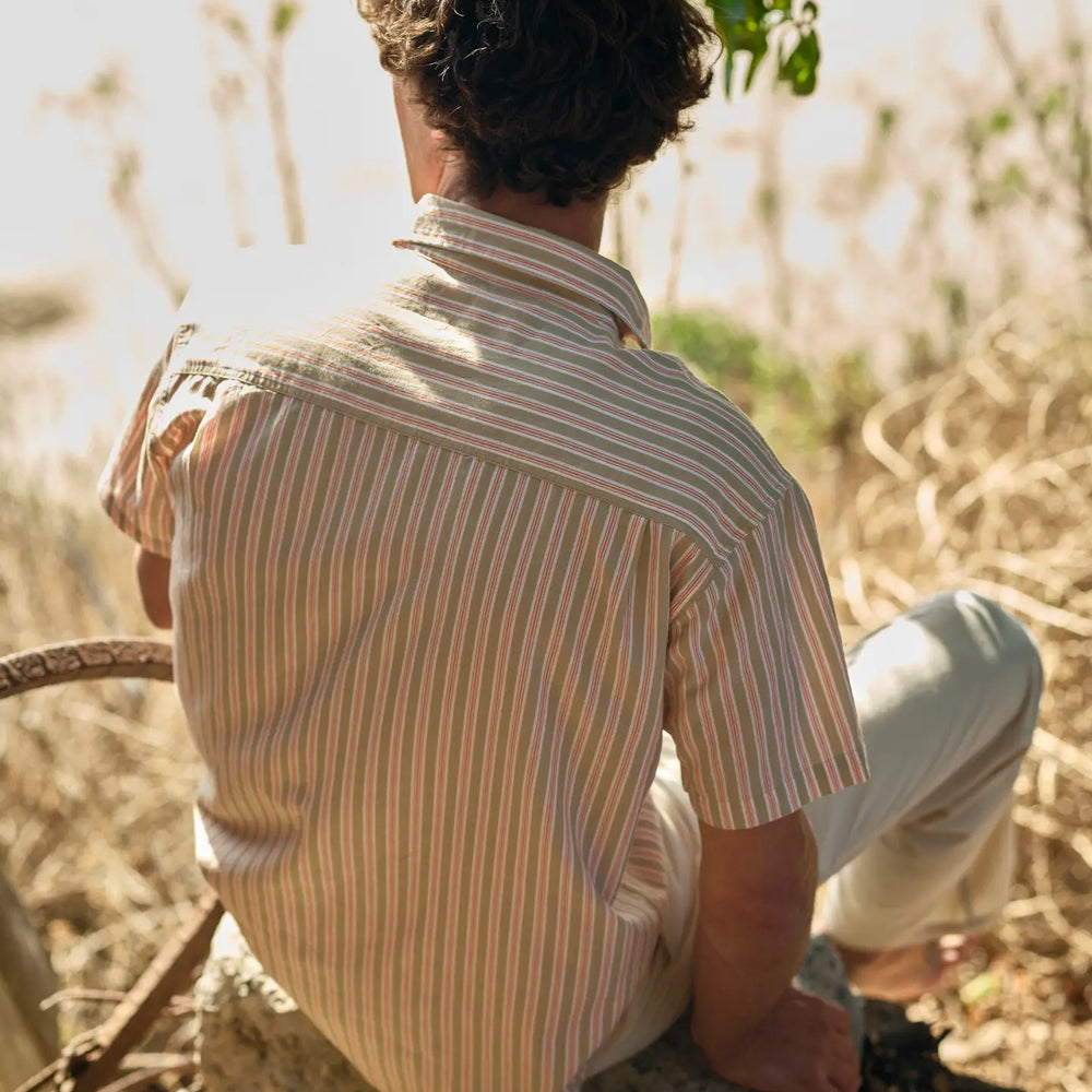 Man wearing a striped short sleeve button down shirt from Mollusk