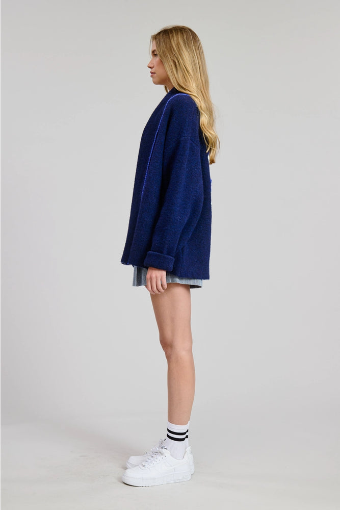 
                      
                        Person wearing a blue oversized sweater from Flat White
                      
                    