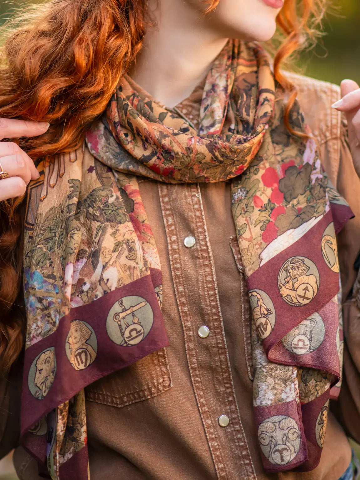 A woman wearing the Dreamweaver Bohemian Bamboo Scarf with Zodiac Signs by Market of Stars as a scarf around her neck