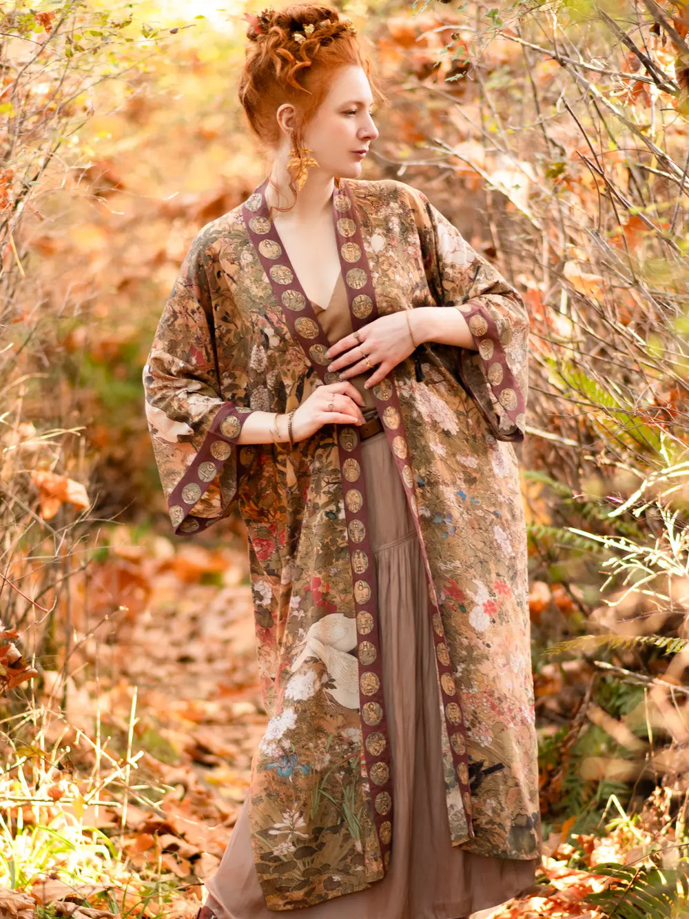 A woman standing outside while wearing the Dreamweaver Zodiac Kimono Duster Robe by the brand Market Of Stars