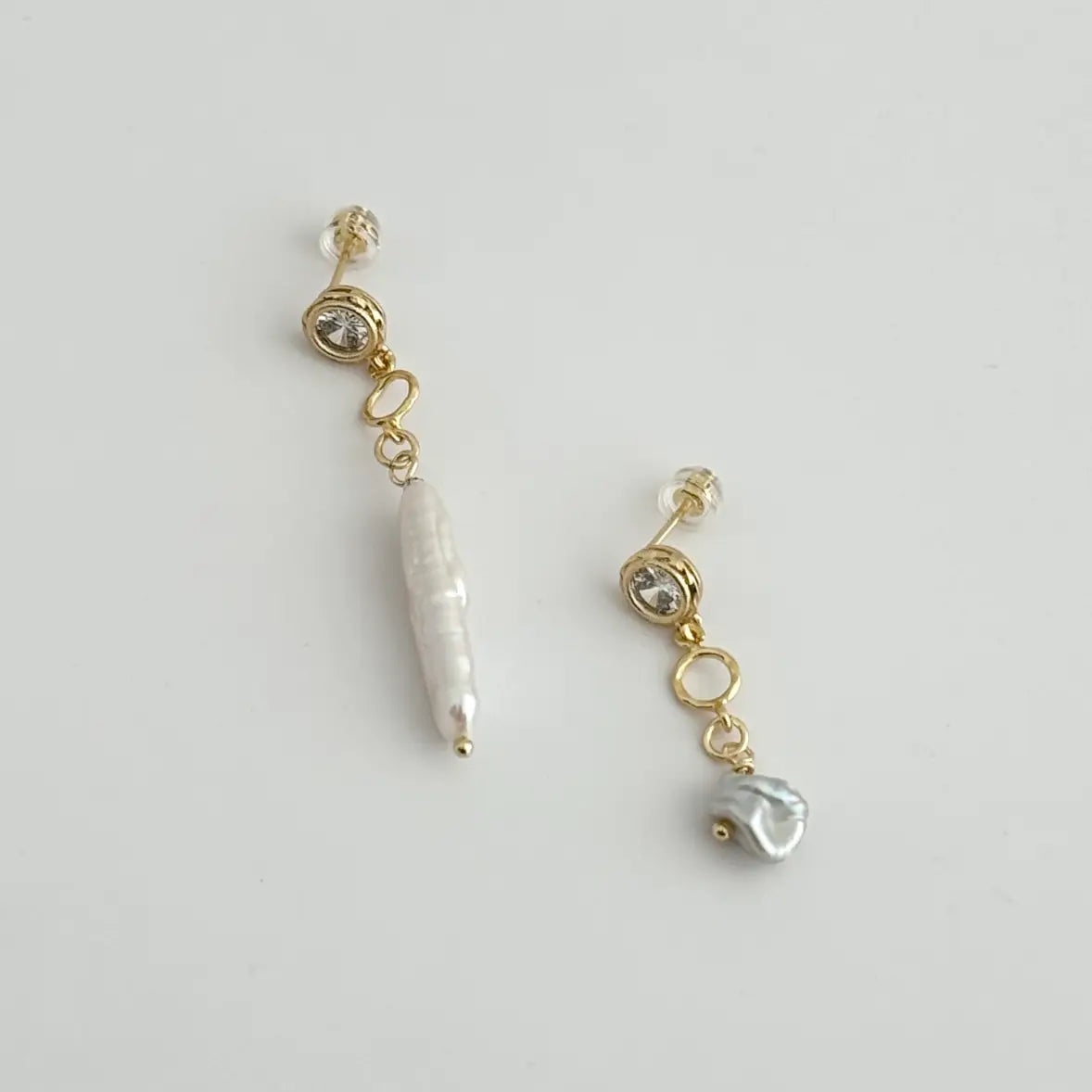 The Tramps + Thieves Megane Mix Match Earrings at Harbour Thread are gold filled clear CZ stud and Pearl Drop earrings adorned with biwa and baroque shaped freshwater pearls