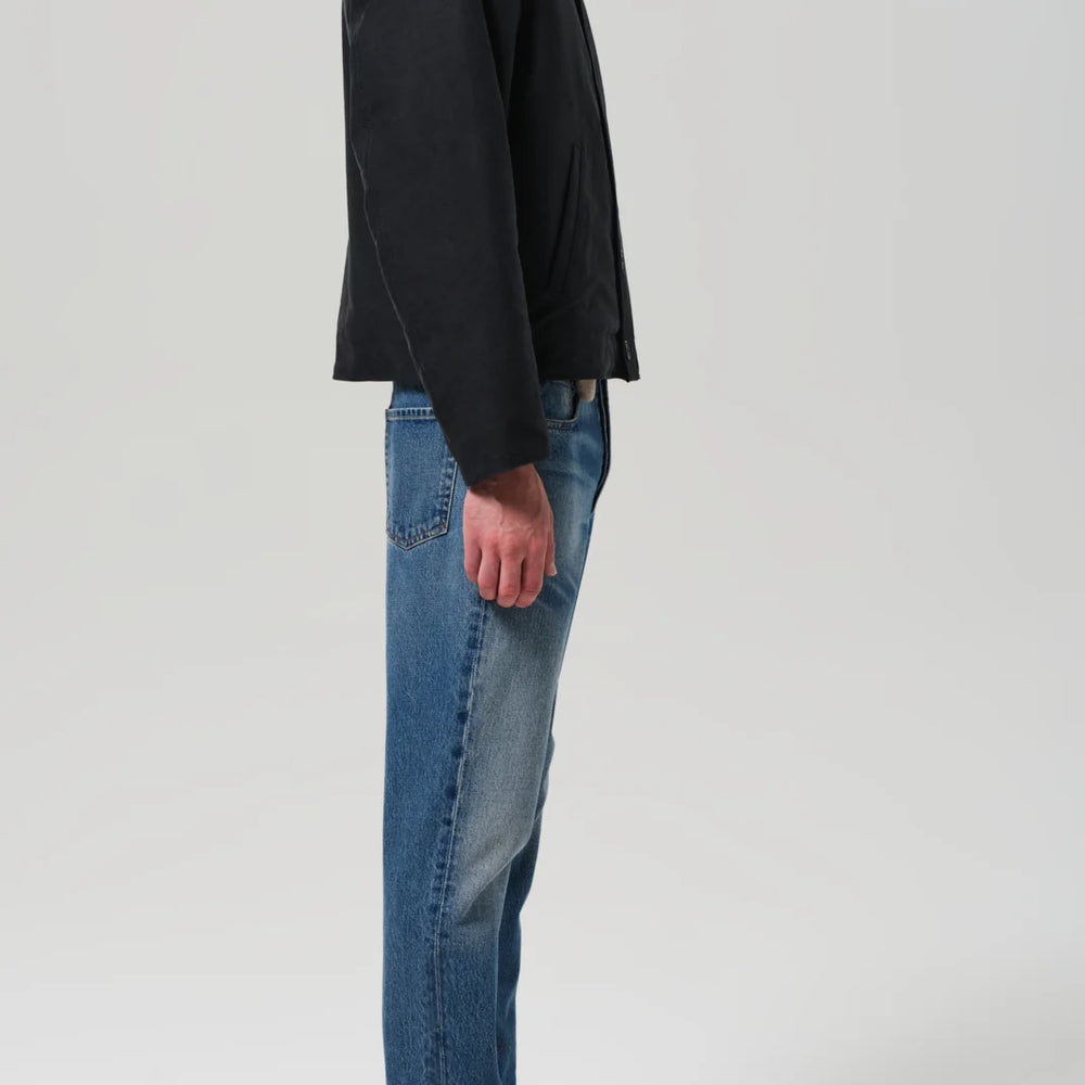 
                      
                        Person wearing a black jacket and blue jeans from Citizens of Humanity
                      
                    