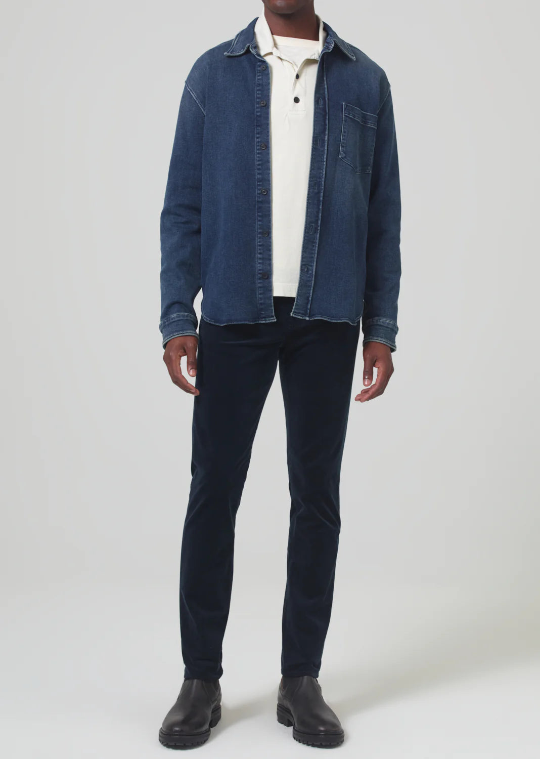 A man wearing the Navy London Tapered Slim Velvet men's pant by Citizens Of Humanity