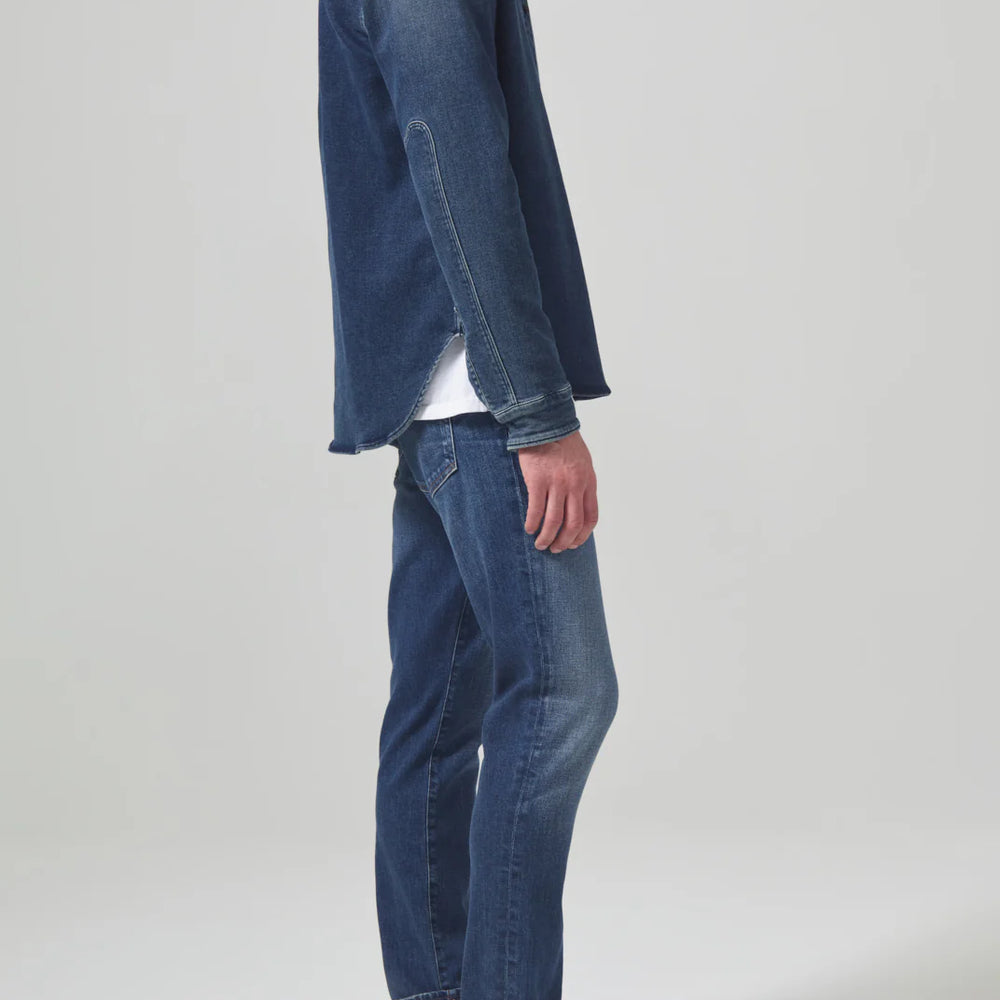 
                      
                        Side view of a man wearing the Parquet London Tapered Slim Archive Men's Jeans by Citizens Of Humanity
                      
                    
