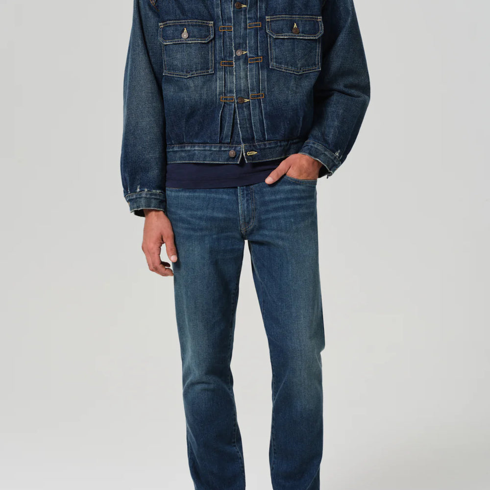 A man wearing the Gage Slim Straight Archive jeans by Citizens of Humanity, in the color Kinetic