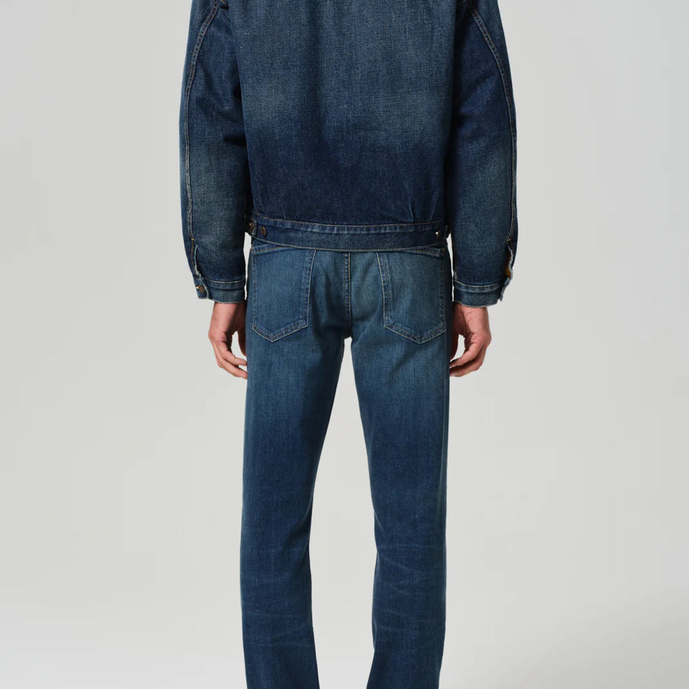 Back view of a man wearing the Gage Slim Straight Archive jeans by Citizens of Humanity, in the color Kinetic