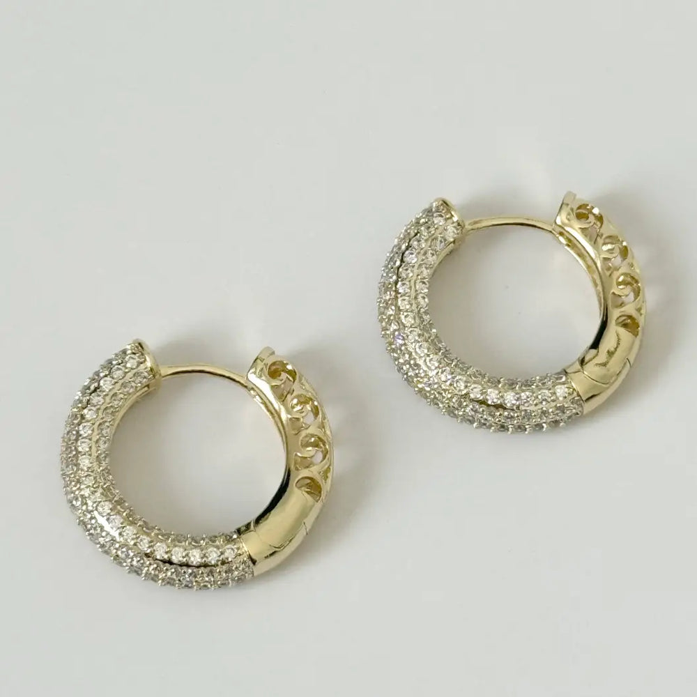 The 14K Gold Filled Santira Hoops by Tramps + Thieves are available at Harbour Thread for your next event, and feature a split mix of clear CZ stones and a gold lace design.