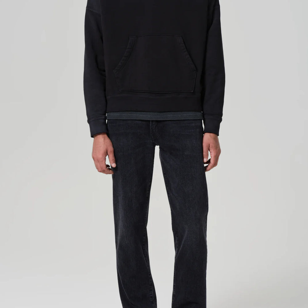 A man wearing the Elijah Straight Archive Men's Jeans in the color Grotto