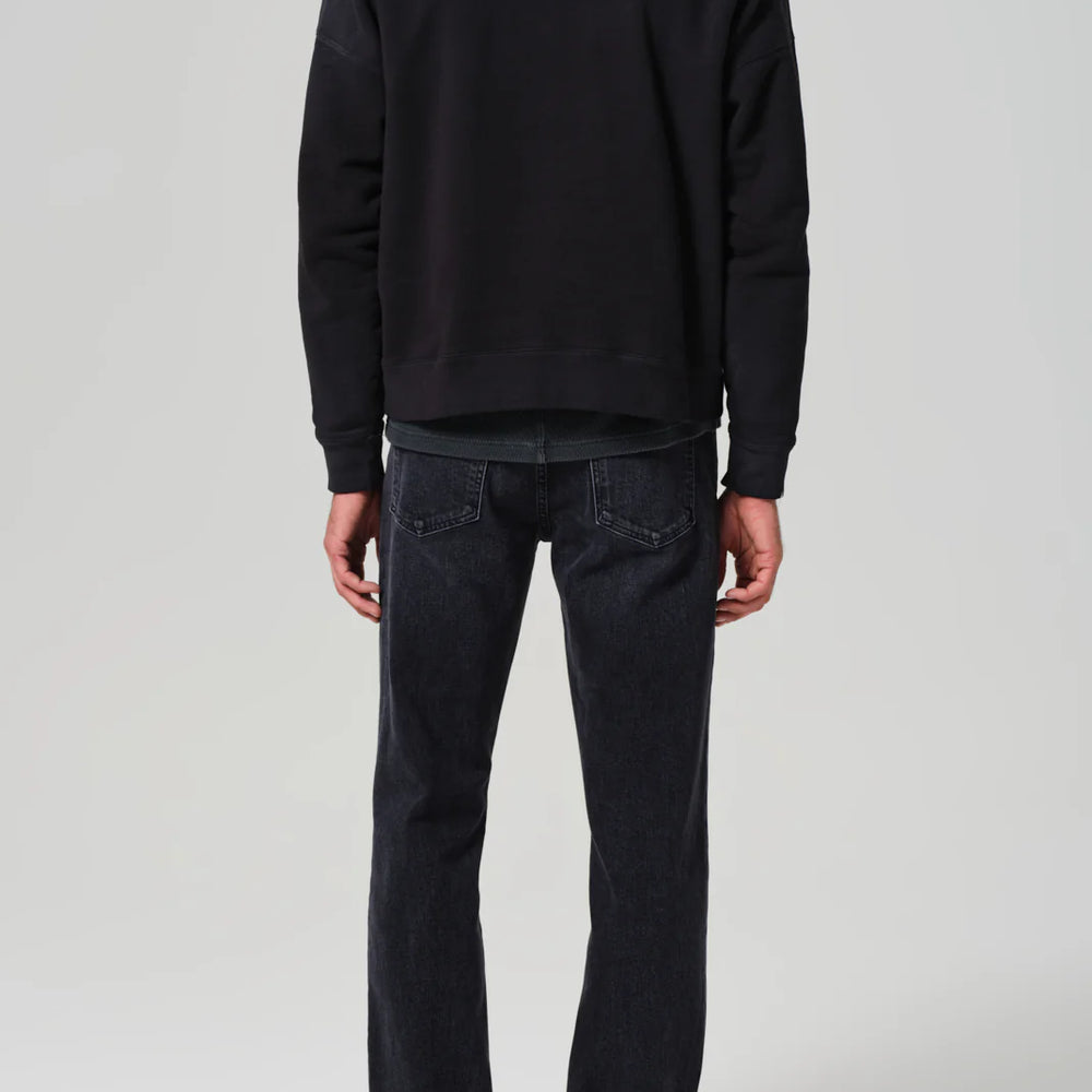 Back view of a man wearing the Elijah Straight Archive Men's Jeans in the color Grotto