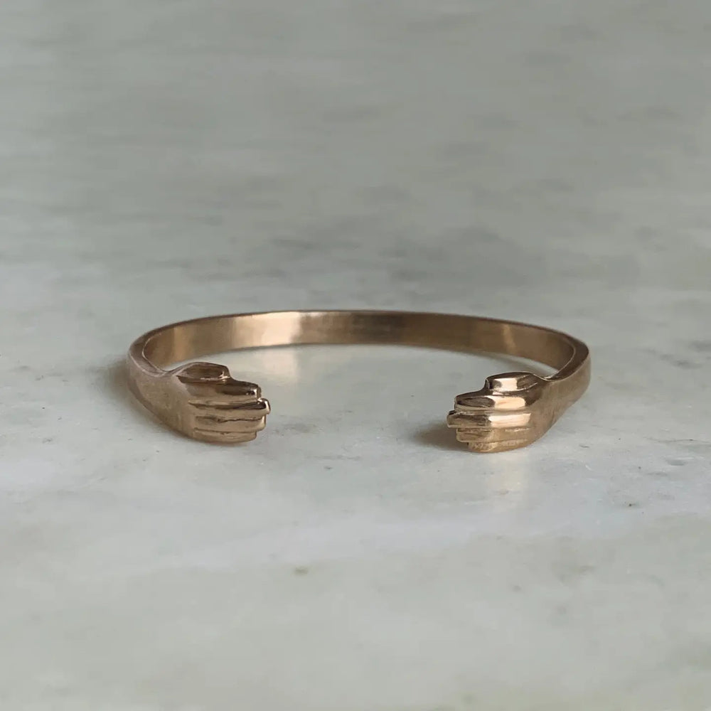 Bronze bangle cuff bracelet with hand detail at each end