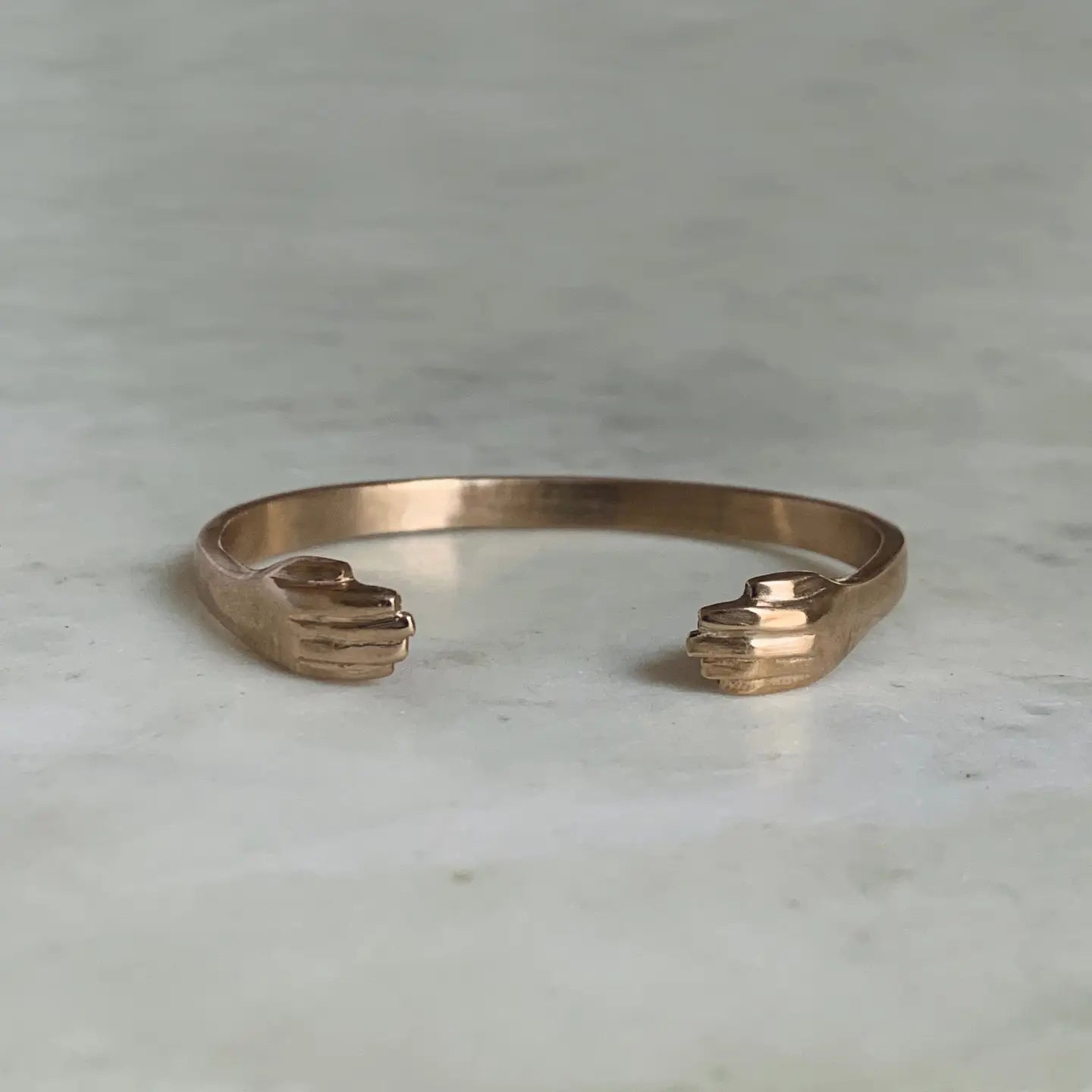 Bronze bangle cuff bracelet with hand detail at each end