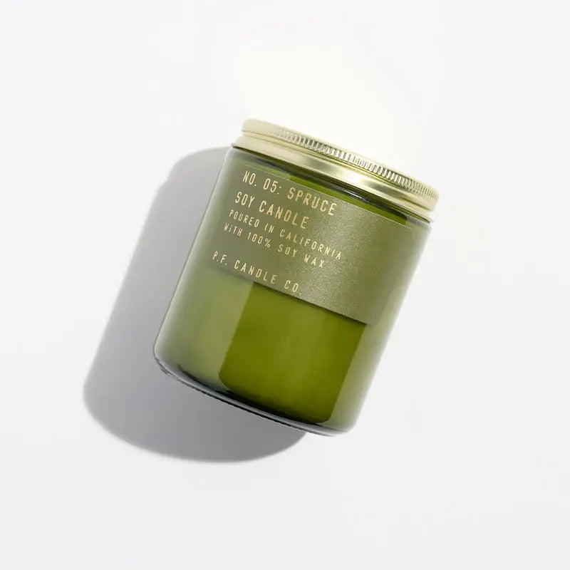 
                      
                        The Spruce Soy Candle by P.F. Candle Co. packaged in a green jar with a lid
                      
                    